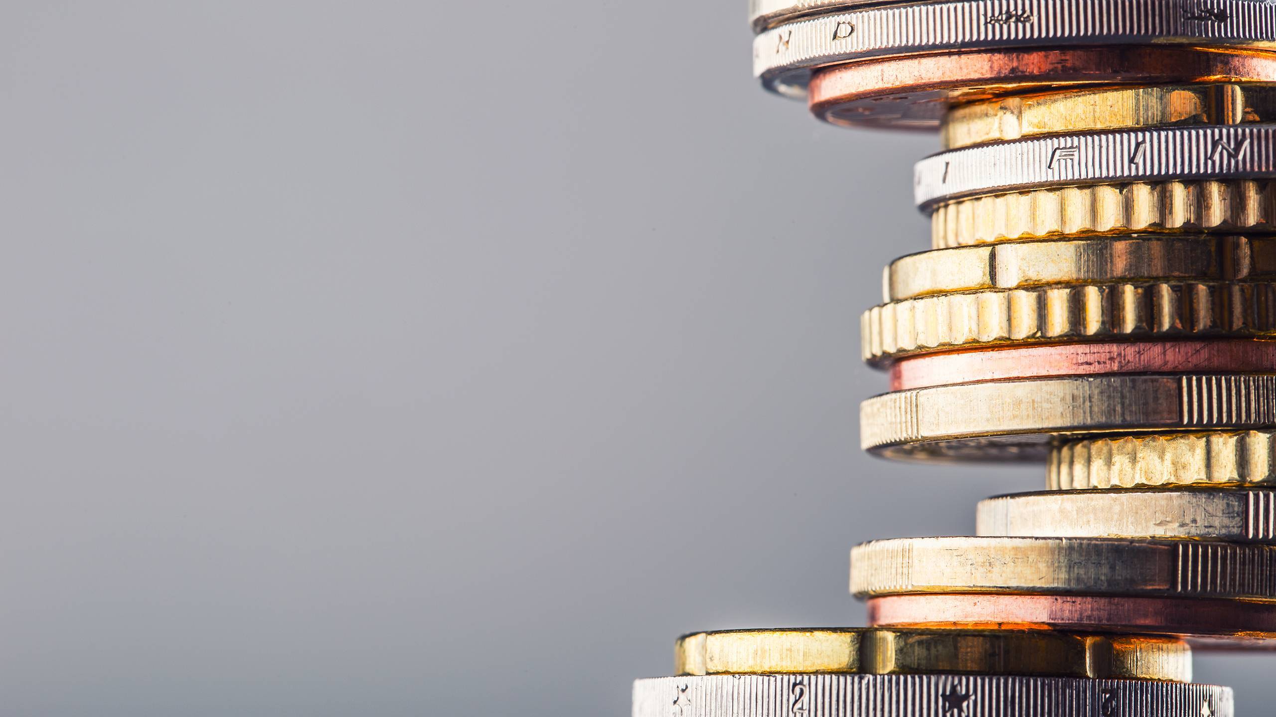 stacked coins with a grey background