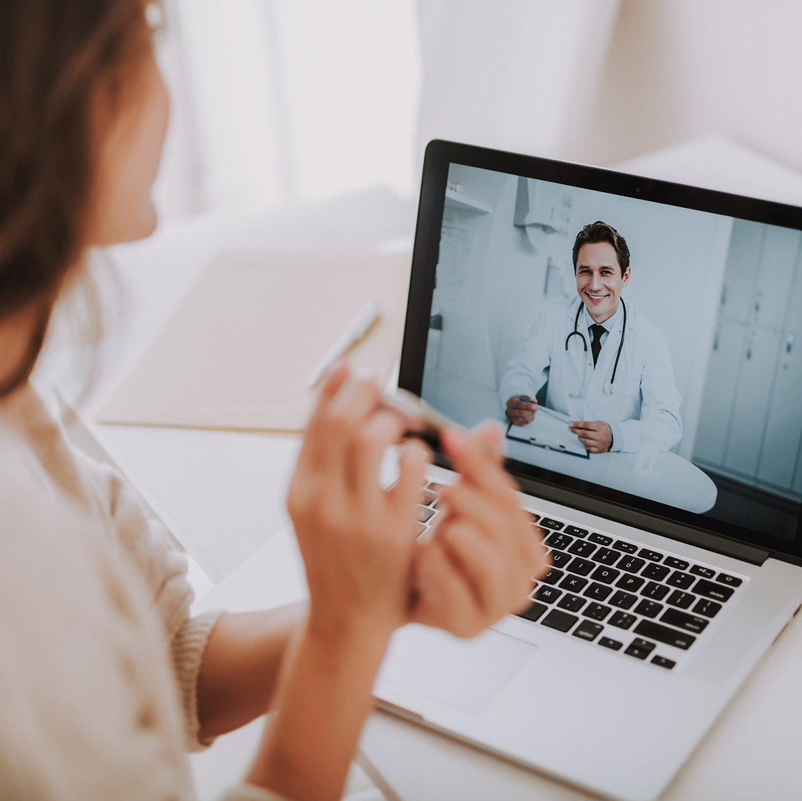 Patient speaking to doctor on laptop