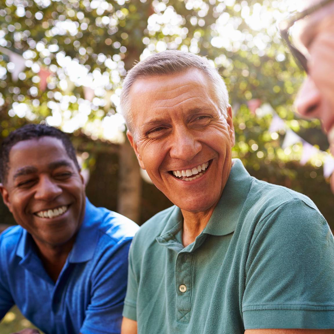 group of three men smiling