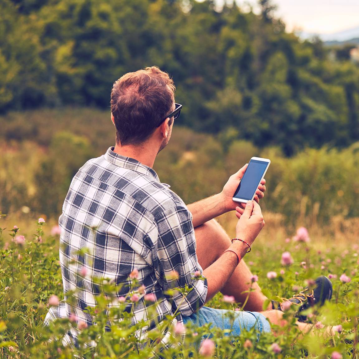 man in field using phone