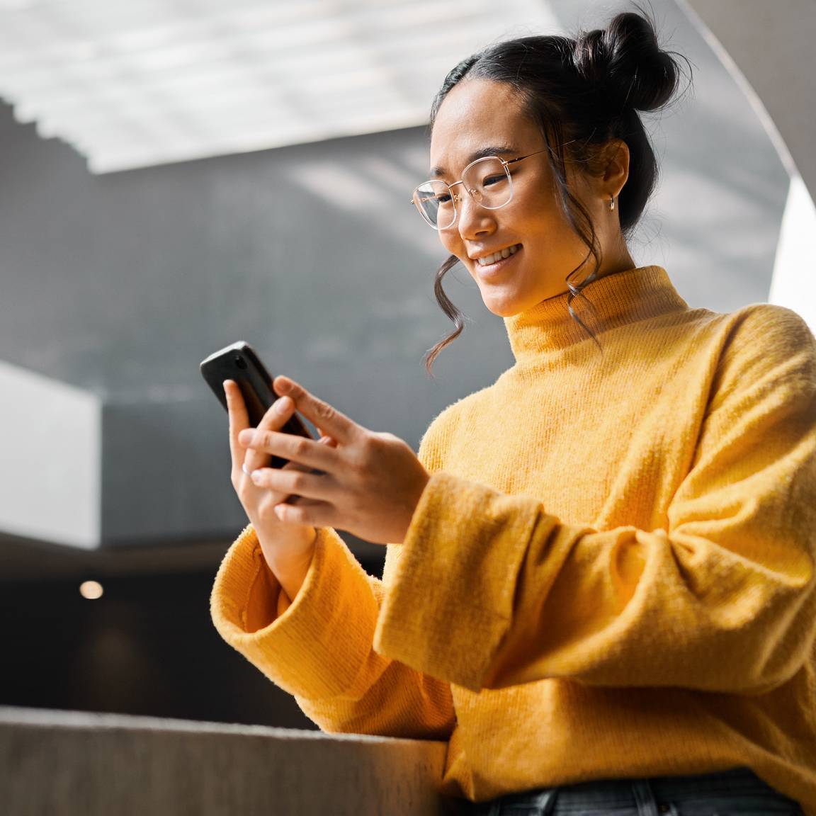 woman in office building using phone