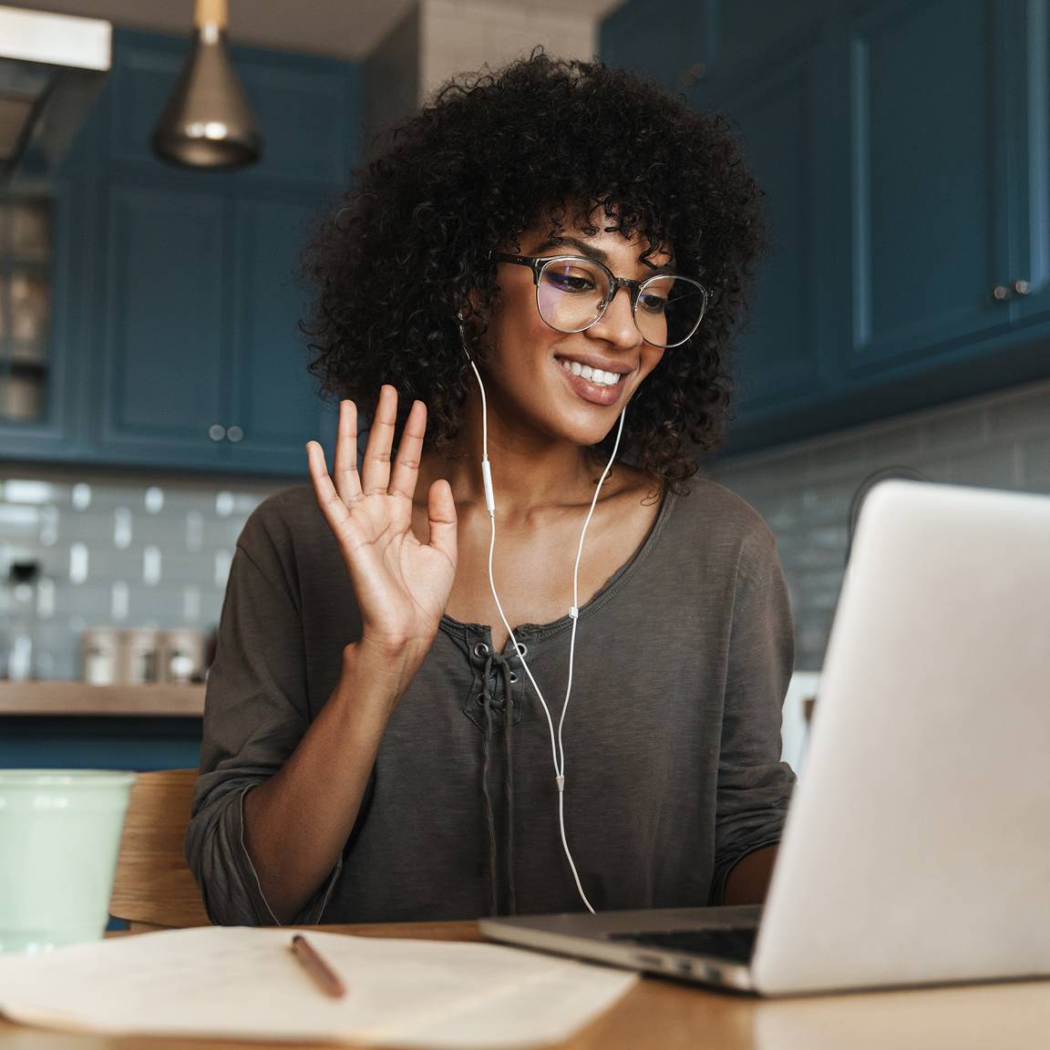 woman with earplugs on online call